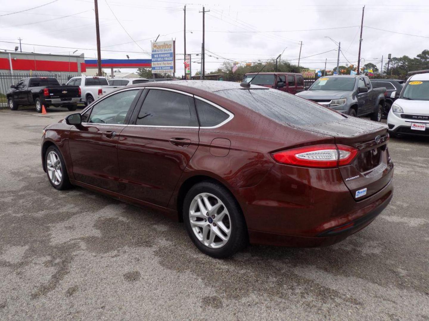 2016 BROWN FORD FUSION SE (3FA6P0HD6GR) with an 1.5L engine, Automatic transmission, located at 830 E. Canino Rd., Houston, TX, 77037, (281) 405-0440, 38.358219, -81.729942 - Photo#4