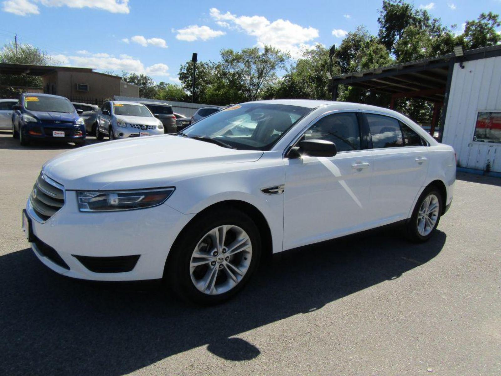 2015 WHITE FORD TAURUS SE (1FAHP2D89FG) with an 3.5L engine, Automatic transmission, located at 830 E. Canino Rd., Houston, TX, 77037, (281) 405-0440, 38.358219, -81.729942 - Photo #0