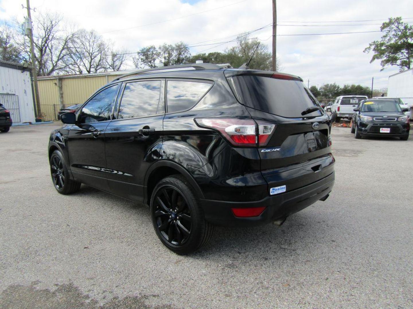 2018 BLACK FORD ESCAPE SE (1FMCU9GD2JU) with an 1.5L engine, Automatic transmission, located at 830 E. Canino Rd., Houston, TX, 77037, (281) 405-0440, 38.358219, -81.729942 - Photo#2
